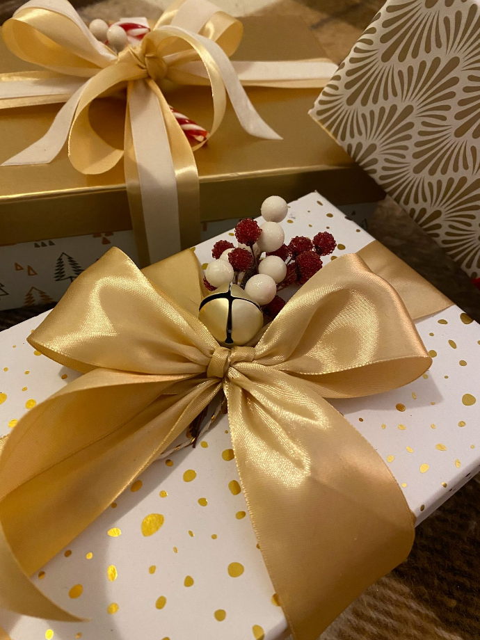 a present wrapped in gold and white ribbon
